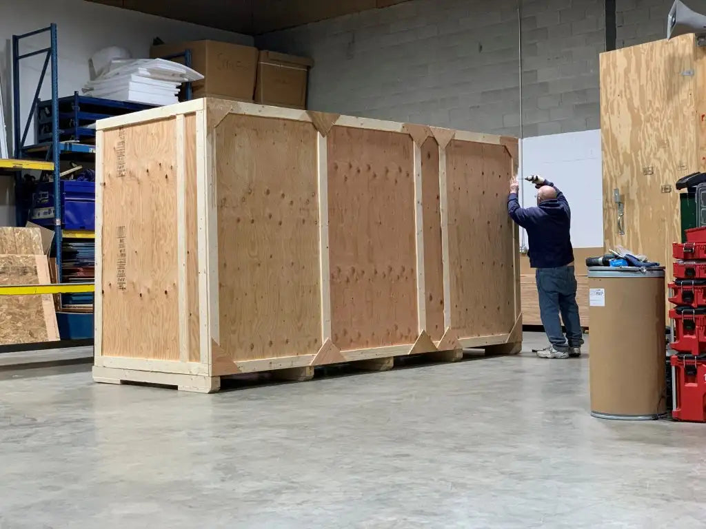 Large wooden crate with reinforced corners and visible plywood panels.